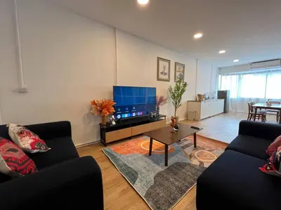 a living room with two couches and a flat screen tv at Roof Top 4BR Top Private Floor, china town, center in Bangkok