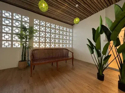 a bench in a room with plants and windows at Roof Top 4BR Top Private Floor, china town, center in Bangkok