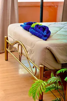 a bed with a blanket on top of it at Hostel Bangkok BM B&B in Bangkok