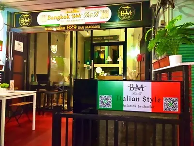 a restaurant with a sign in front of it at BM Loft On Nut & Massage in Bangkok