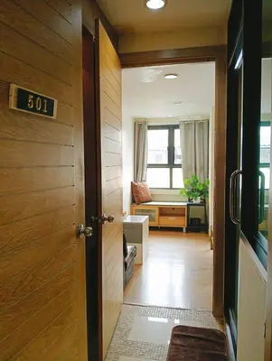 an open door to a hallway with a living room at BM Loft On Nut & Massage in Bangkok