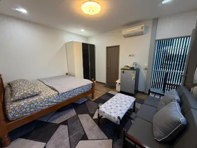a bedroom with a bed and a couch in it at Number9 Bangkoknoi BKK Homestay in Bangkok