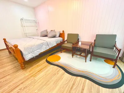 a bedroom with a bed and two chairs and a table at Number9 Bangkoknoi BKK Homestay in Bangkok