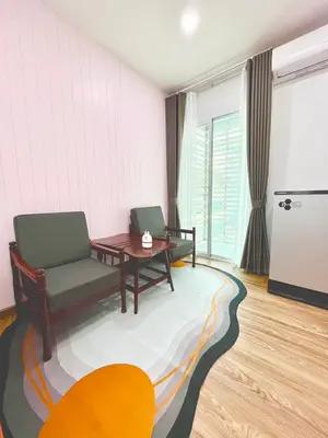 a living room with two chairs and a table at Number9 Bangkoknoi BKK Homestay in Bangkok