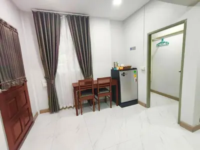 a kitchen with a table and a refrigerator in a room at Number9 Bangkoknoi BKK Homestay in Bangkok