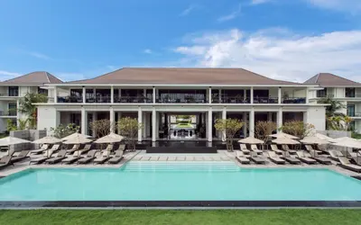 a resort with a pool and chairs and a building at U Sathorn Bangkok in Bangkok