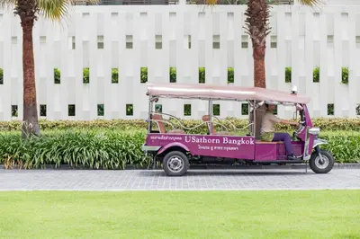 a woman driving a purple golf cart at U Sathorn Bangkok in Bangkok