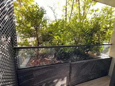 a balcony with a garden with trees and plants at Willow Whisper Nest in Bangkok