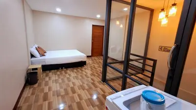 a small room with a bed and a mirror at NEW! KG home 3 Bedrooms/ Free Wi-Fi in Bangkok