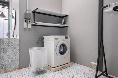 a washing machine in a laundry room with a camera at MIQ Ekkamai2 3BR Designer home Oval Bathtub 15pax in Bangkok