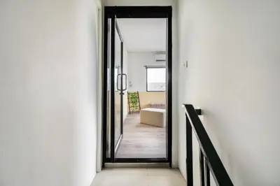 a hallway with a door leading to a bathroom at MIQ Ekkamai1 - 5BR house 65 inch TV in Bangkok