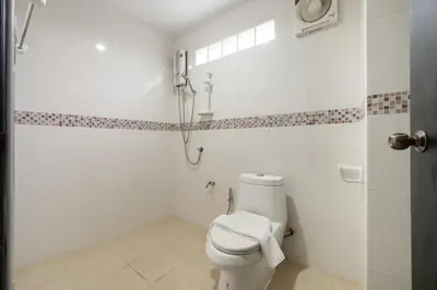 a white bathroom with a toilet and a shower at MIQ Ekkamai1 - 5BR house 65 inch TV in Bangkok