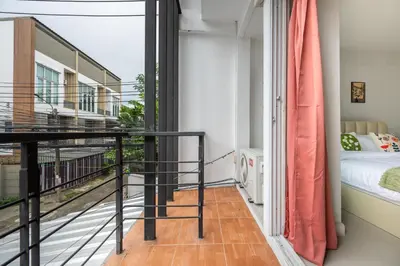 a room with a balcony with a bed at MIQ Ekkamai1 - 5BR house 65 inch TV in Bangkok
