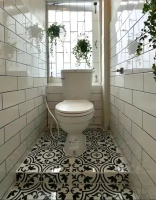 a bathroom with a toilet with a black and white tile floor at 4 Bedroom House with Beautiful Rooftop near BTS Ekkamai in Bangkok