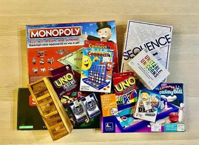 a pile of toys and games on a table at 4 Bedroom House with Beautiful Rooftop near BTS Ekkamai in Bangkok
