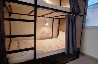 a couple of bunk beds in a room at Chaiwat Hostel in Bangkok