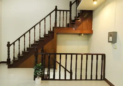 a staircase in a house with a potted plant at Chaiwat Hostel in Bangkok