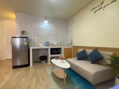 a living room with a couch and a table at PTJ Style Condotel คอนโดเมืองทอง P1 in Ban Song Hong