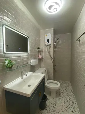 a bathroom with a sink and a toilet and a tv at PTJ Style Condotel คอนโดเมืองทอง P1 in Ban Song Hong
