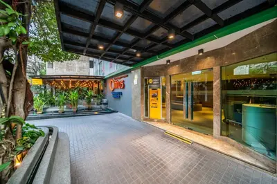 a building with a walkway in front of a store at Citrus Sukhumvit 11 by Compass Hospitality in Bangkok