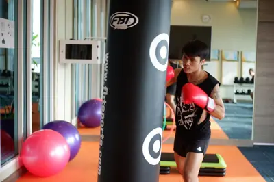 a young man boxing in a gym at Citrus Sukhumvit 11 by Compass Hospitality in Bangkok