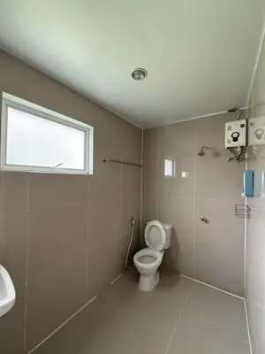 a bathroom with a toilet and a sink and a window at Greenhouse Bangkok Khaosan in Bangkok