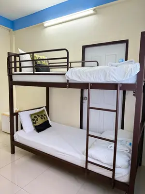 two bunk beds in a room with a pillow at Greenhouse Bangkok Khaosan in Bangkok