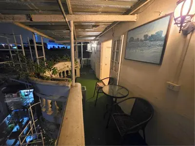 a balcony with a table and chairs and a potted plant at Greenhouse Bangkok Khaosan in Bangkok