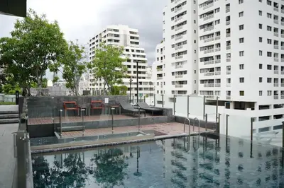 a pool of water with two tall buildings at Circle Rein Sukhumvit 12 two bedrooms apartment in Khlong Toei