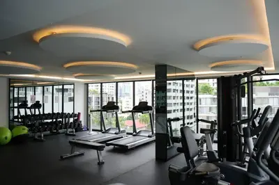 a gym with a bunch of tread machines in a building at Circle Rein Sukhumvit 12 two bedrooms apartment in Khlong Toei