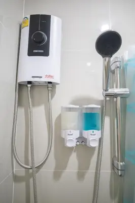 a bathroom with a hair dryer on a wall at Bangkok Cozy Home @Khaosan Road in Bangkok