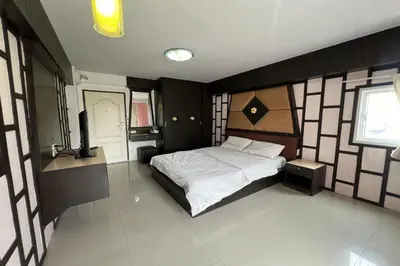 a bedroom with a large bed in a room at Phongsathon Mansion in Bangkok