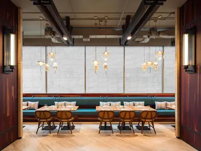 a dining room with a long table and chairs at Mercure Bangkok Surawong in Bangkok