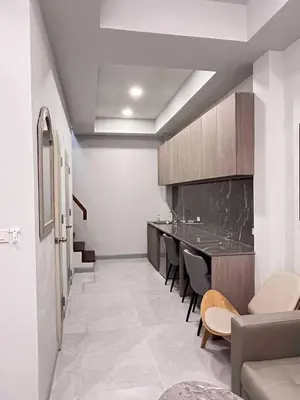 a room with a kitchen with a table and chairs at Pipp Residence in Bangkok