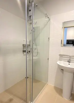 a bathroom with a shower and a toilet and a sink at Pipp Residence in Bangkok