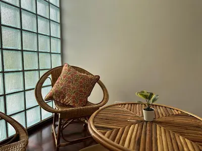 a room with two chairs and a table with a potted plant at Bunya House near BTS Asok, Terminal21 Free BF in Bangkok