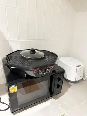 a toaster oven sitting on top of a microwave at Bunya House near BTS Asok, Terminal21 Free BF in Bangkok
