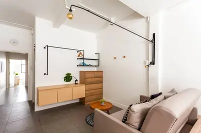 a living room with a couch and a table at MIQ_5br/Silom Bts,Mrt/Wifi 1000MB/Jacuzzi/16pax in Bangkok