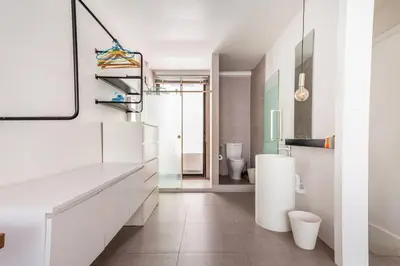 a white bathroom with a sink and a toilet at MIQ_5br/Silom Bts,Mrt/Wifi 1000MB/Jacuzzi/16pax in Bangkok