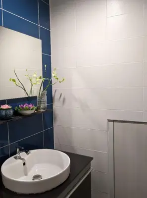 a bathroom with a white sink and a mirror at Old Town- mimi cozy studio *70 SQM good for family in Bangkok