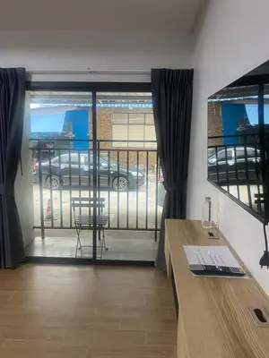 a room with a desk and a view of a parking lot at N place Huai Khwang in Bangkok