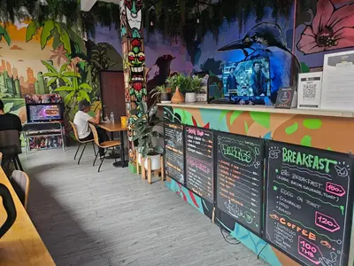 a restaurant with a chalkboard menu and a table at Urban Jungle Social in Bangkok
