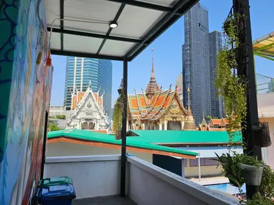 a view of temples from the balcony of a building at Urban Jungle Social in Bangkok