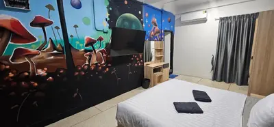 a bedroom with a mural of mushrooms on the wall at Urban Jungle Social in Bangkok