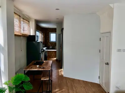 a kitchen and dining room with a table in a room at The Apartium - Modern Apartment Rentals in Bangkok
