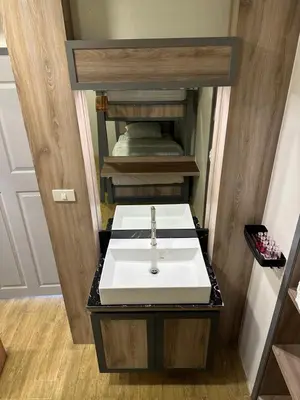 a bathroom with a white sink in a room at Victory Place in Bangkok
