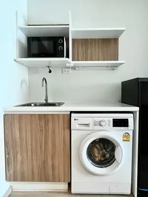 a kitchen with a washing machine and a sink at Elio Sukhumvit 64: Chic Space in Bangkok