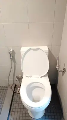 a bathroom with a white toilet in a stall at Elio Sukhumvit 64: Chic Space in Bangkok