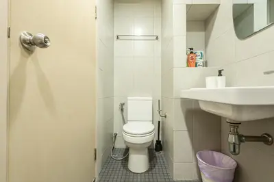 a small bathroom with a toilet and a sink at Elio Del Ray BTS Punnawithi in Bangkok