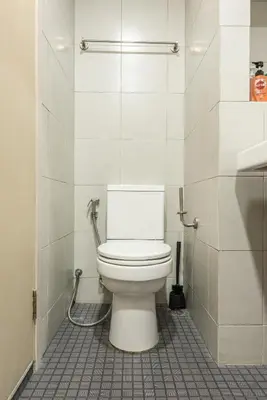 a bathroom with a white toilet in a stall at Elio Del Ray BTS Punnawithi in Bangkok